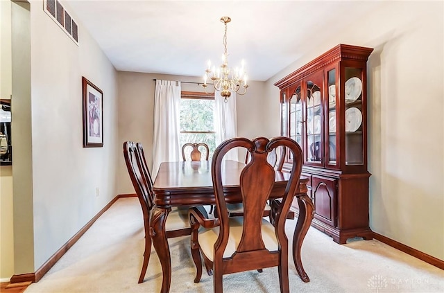 dining room with light carpet, baseboards, visible vents, and an inviting chandelier