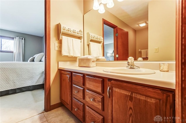 ensuite bathroom featuring ensuite bathroom, vanity, and tile patterned floors