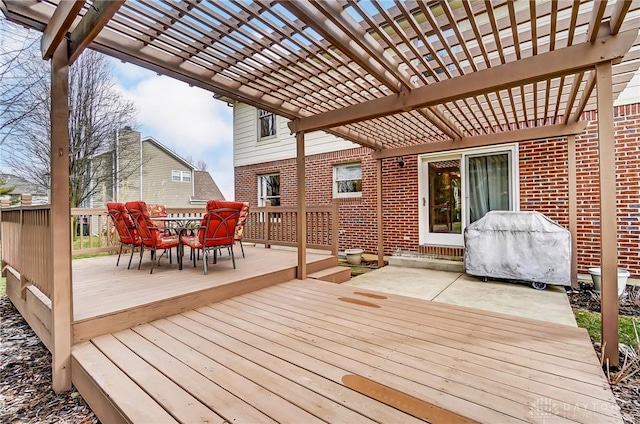 wooden deck featuring grilling area and a pergola