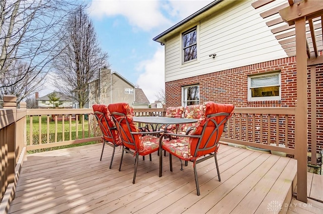 wooden terrace featuring outdoor dining space