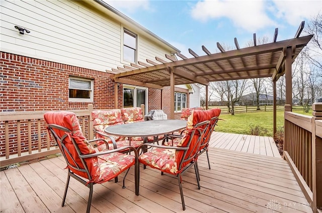 wooden deck with outdoor dining space, a lawn, and a pergola