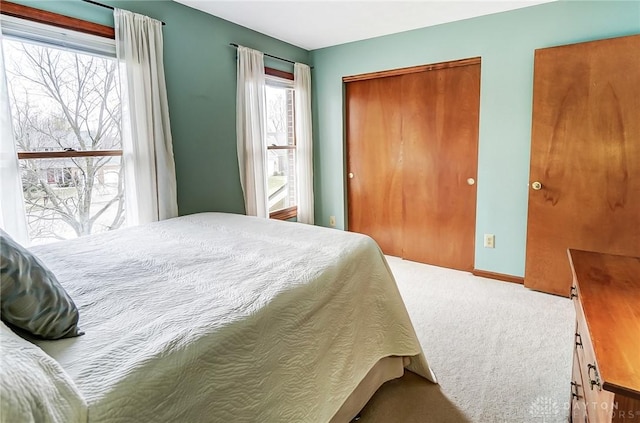 carpeted bedroom featuring baseboards