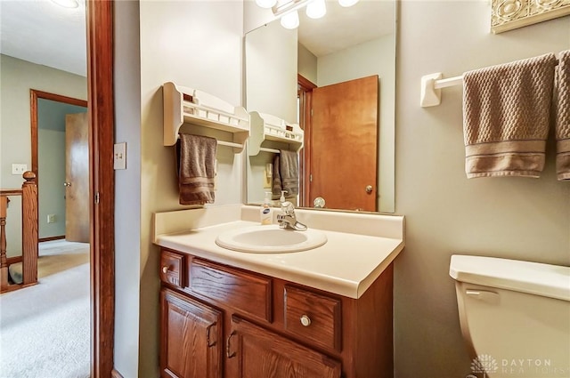 bathroom with toilet and vanity