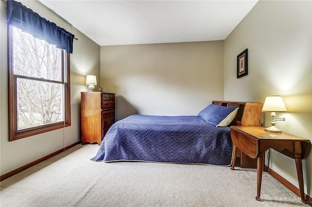 bedroom with baseboards, multiple windows, and carpet flooring