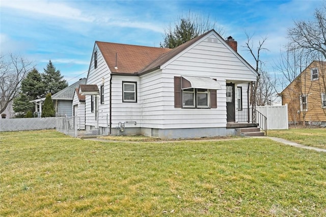 bungalow-style home featuring a front lawn, a chimney, and fence