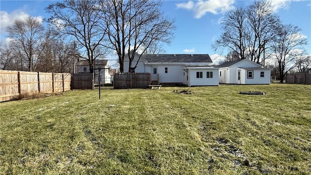 back of property with a lawn and fence private yard