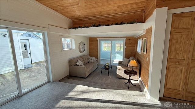 sitting room with wood ceiling, carpet, wooden walls, and vaulted ceiling