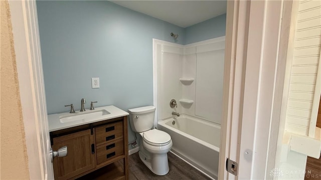 full bath with toilet, shower / bath combination, wood finished floors, and vanity