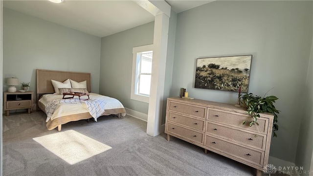 bedroom with carpet floors and baseboards