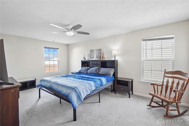 bedroom with ceiling fan, carpet, and baseboards