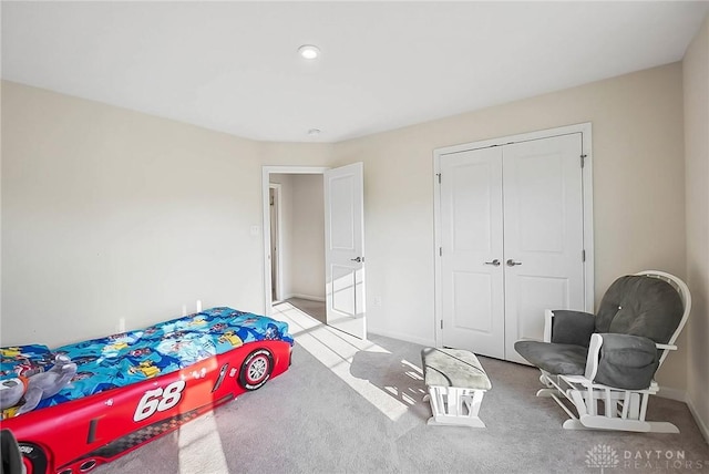 bedroom with carpet floors, a closet, and baseboards