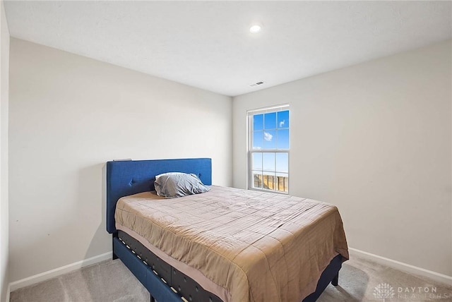 bedroom with carpet, visible vents, and baseboards