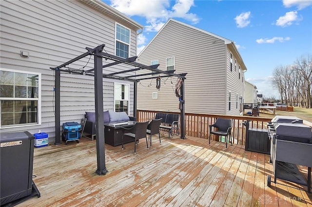 wooden terrace with an outdoor living space and a pergola