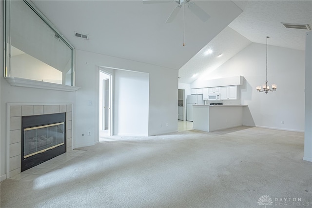 unfurnished living room with light carpet, a fireplace, and visible vents