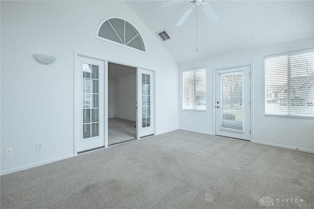 unfurnished sunroom featuring ceiling fan, visible vents, vaulted ceiling, and french doors