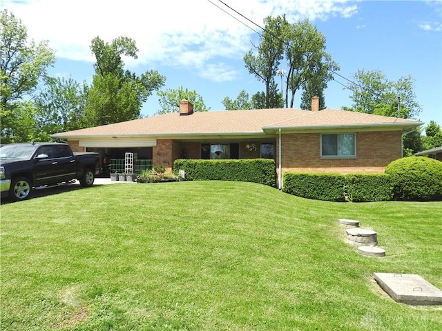 ranch-style house with an attached garage, brick siding, and a front yard