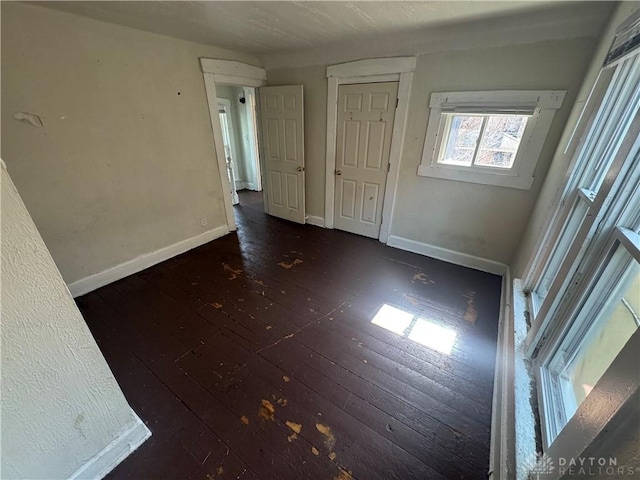 empty room featuring hardwood / wood-style floors and baseboards