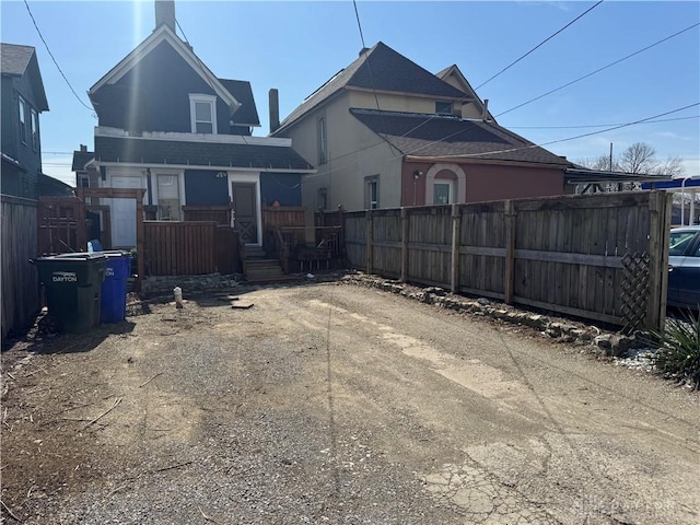 rear view of house with fence