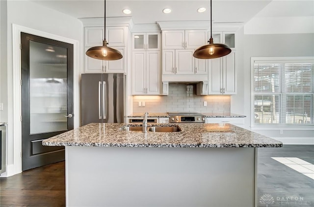 121 Lowe Ln, Dayton, OH 45402 - kitchen featuring stainless steel appliances, a sink, decorative backsplash, and light stone counters