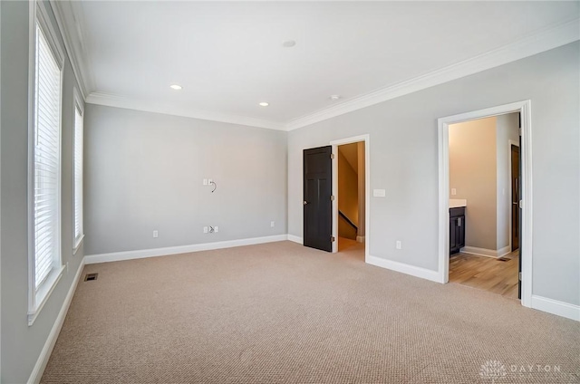 121 Lowe Ln, Dayton, OH 45402 - unfurnished bedroom with light carpet, ornamental molding, a walk in closet, and baseboards