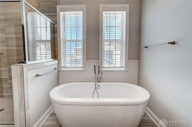 121 Lowe Ln, Dayton, OH 45402 - bathroom featuring a stall shower and a freestanding tub