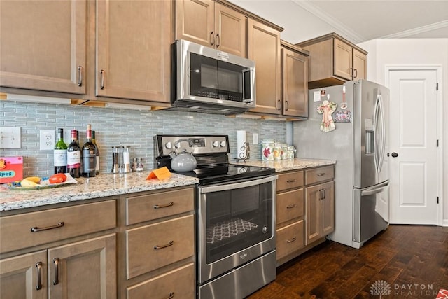 kitchen featuring light stone counters, stainless steel appliances, backsplash, dark wood-style floors, and crown molding