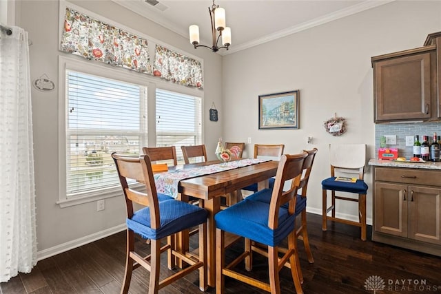 dining space with a notable chandelier, baseboards, ornamental molding, and dark wood-type flooring