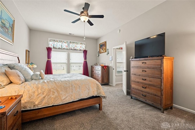 bedroom featuring light carpet, ceiling fan, and baseboards