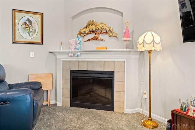 interior details with carpet floors, baseboards, and a tiled fireplace