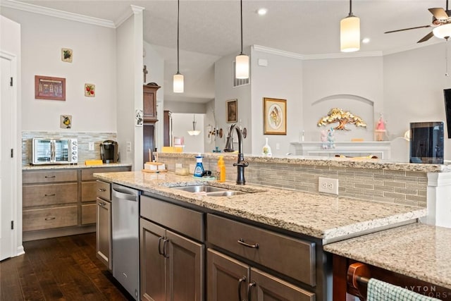 kitchen with light stone counters, a sink, stainless steel dishwasher, dark wood finished floors, and crown molding