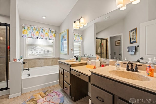 full bathroom featuring a stall shower, a garden tub, and vanity