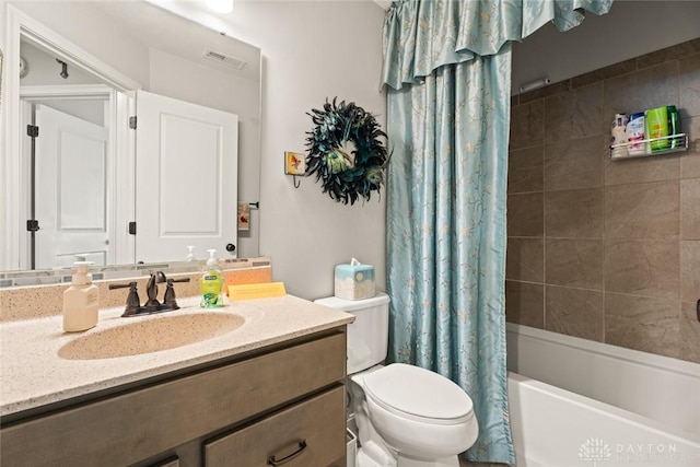 full bathroom featuring toilet, shower / tub combo, vanity, and visible vents