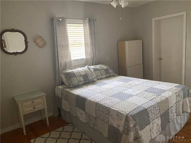 bedroom with wood finished floors and baseboards