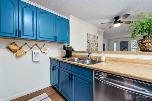 kitchen with dishwasher, a sink, and blue cabinetry