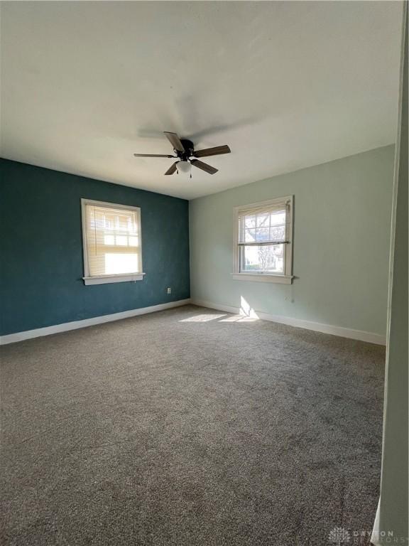 50 Woodcrest Ave, Dayton, OH 45405 - carpeted empty room with baseboards, a ceiling fan, and plenty of natural light