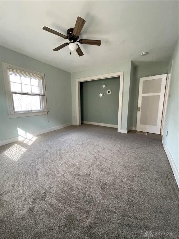50 Woodcrest Ave, Dayton, OH 45405 - unfurnished bedroom featuring baseboards, carpet floors, and a ceiling fan