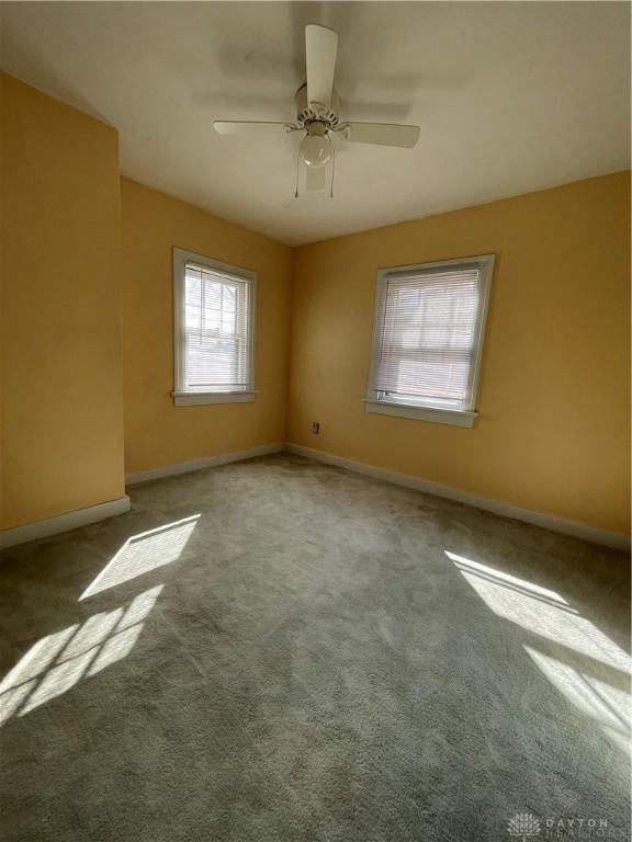 50 Woodcrest Ave, Dayton, OH 45405 - carpeted empty room with baseboards and ceiling fan