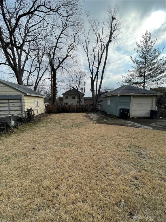 50 Woodcrest Ave, Dayton, OH 45405 - view of yard with an outdoor structure, a garage, and fence
