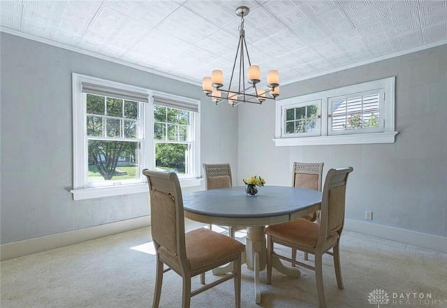 50 Woodcrest Ave, Dayton, OH 45405 - carpeted dining area featuring baseboards, ornamental molding, and an inviting chandelier