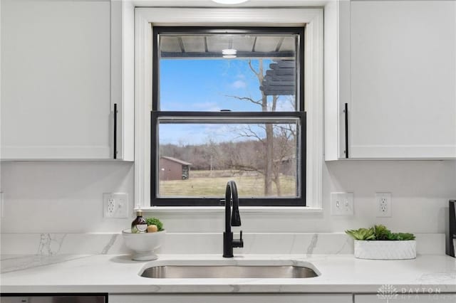 details featuring white cabinetry and a sink