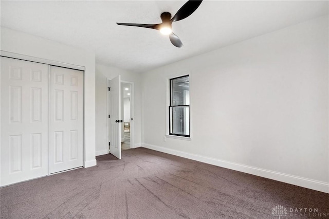 unfurnished bedroom with a closet, carpet flooring, ceiling fan, and baseboards