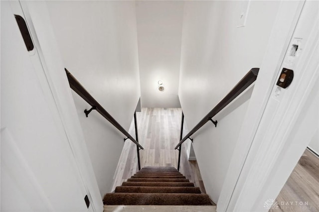 staircase with wood finished floors