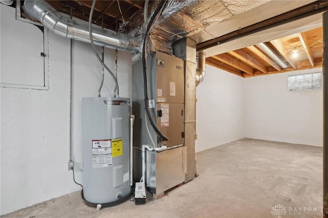 unfinished below grade area featuring heating unit and water heater