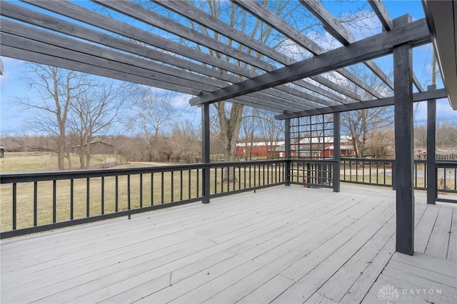 wooden terrace featuring a yard and a pergola