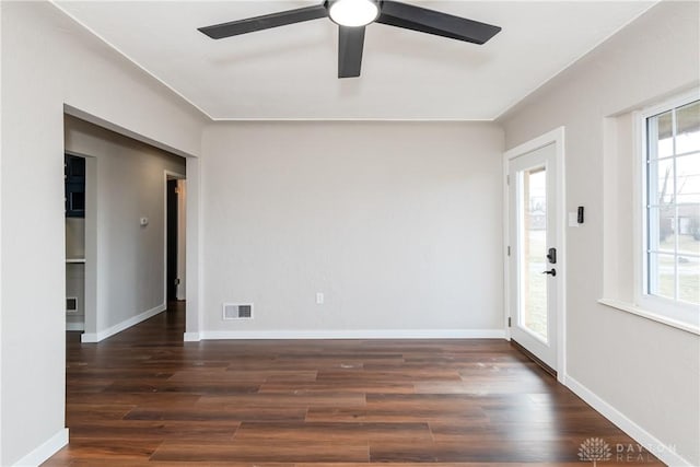 interior space with baseboards, visible vents, and wood finished floors