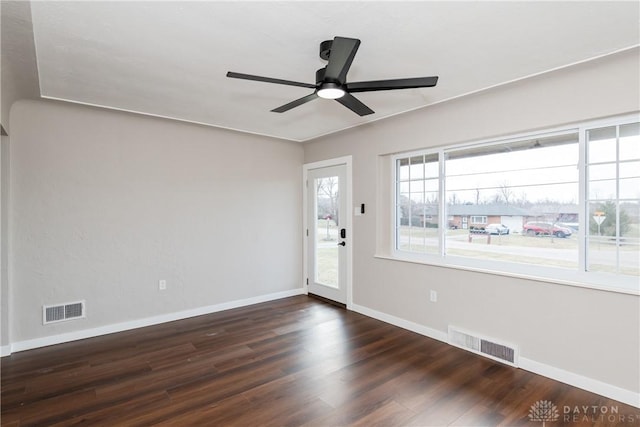 empty room with a ceiling fan, baseboards, visible vents, and wood finished floors