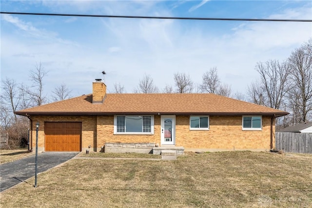 ranch-style home featuring an attached garage, fence, driveway, a front lawn, and a chimney