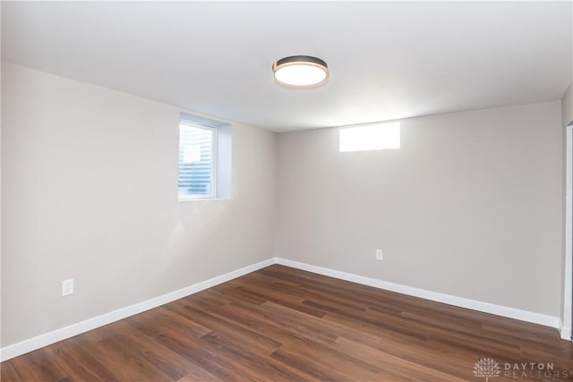 interior space with dark wood-style flooring and baseboards