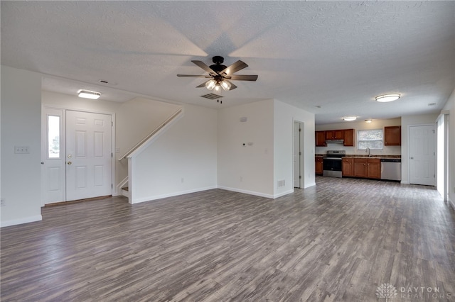 unfurnished living room featuring baseboards, visible vents, dark wood finished floors, and a sink