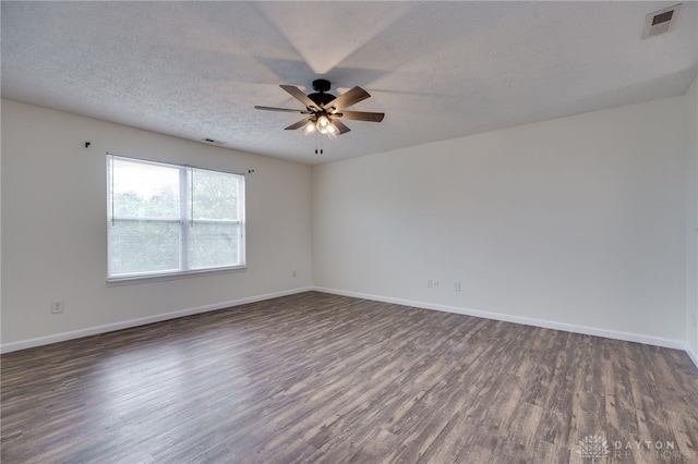 unfurnished room featuring a textured ceiling, wood finished floors, a ceiling fan, and baseboards